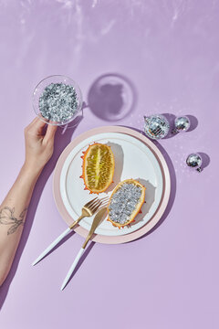 Glass of glitter and decorated kiwano fruit