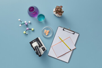 Microscope and notebook with pencil