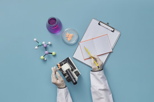 Scientist analyzing cells with microscope