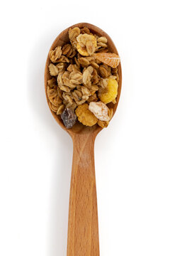 crunchy granola in wooden spoon isolated on white background