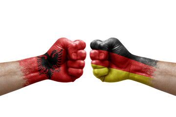 Two hands punch to each others on white background. Country flags painted fists, conflict crisis concept between albania and germany - obrazy, fototapety, plakaty
