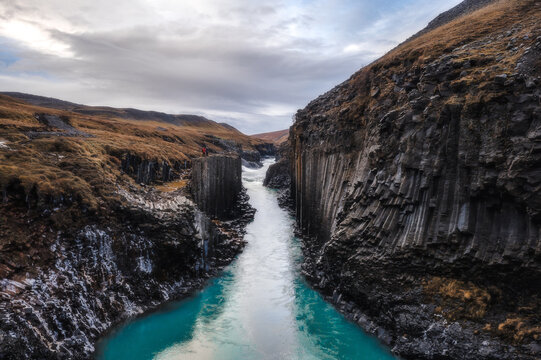 Couple standing on basalt cliff and canyon.