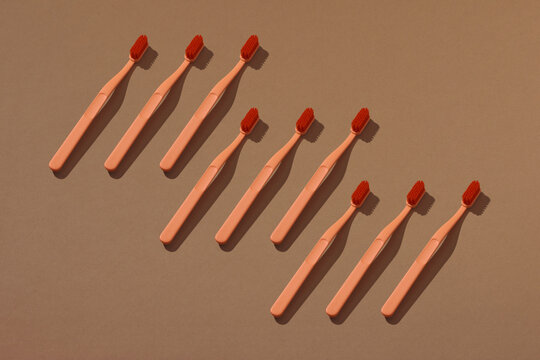 Toothbrush minimal pattern on brown background. 