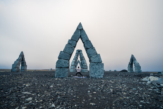 Girl practicing warrior 2 pose at arctic henge.