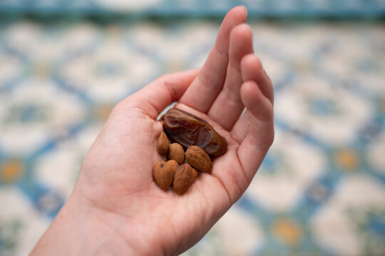 Close-up of dates and nuts on hand