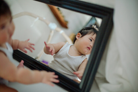Asian baby reflected in mirror