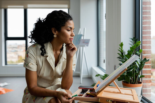 Attractive woman painting at studio