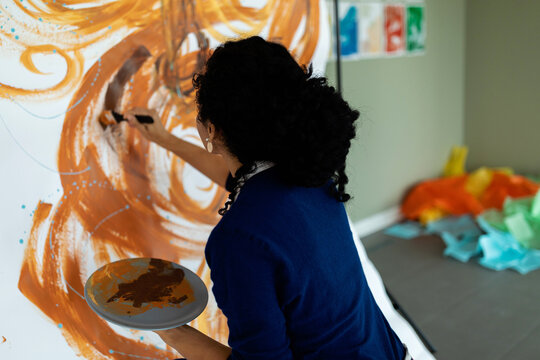 Creative woman painting picture at studio