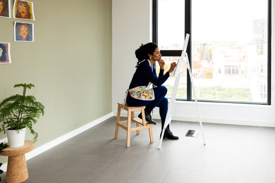 Woman painting picture at studio