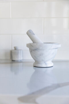 Single Mortar and Pestle on marble countertop in Kitchen 