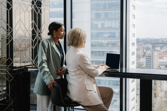 Diverse Businesswomen Working Together On Netbook