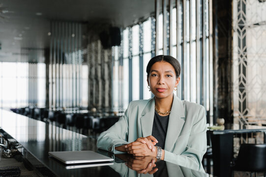 Elegant black businesswoman sitting at counter