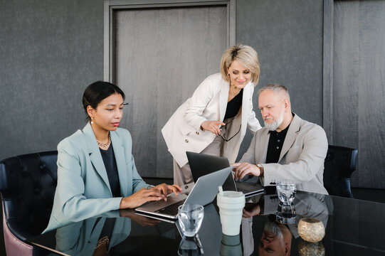 Businesswoman controlling work of diverse employees