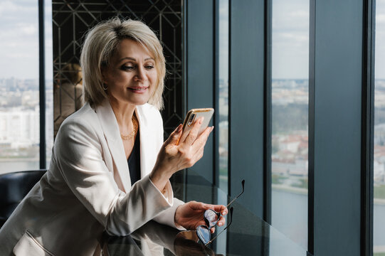 Businesswoman browsing modern smartphone