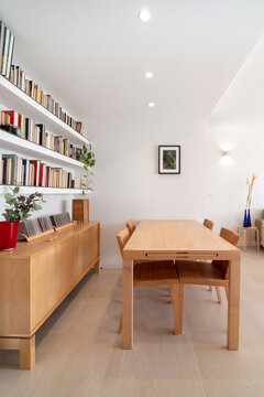 Wooden table and bookshelf in lounge