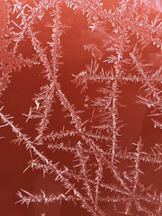 Spiky lines of frost on an orange background