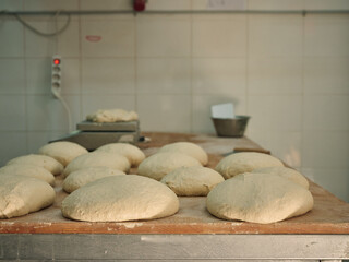 Bakery workshop table with handmade dough loafs