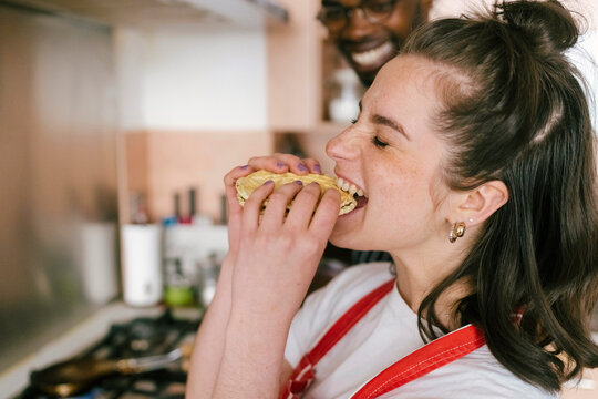 The woman eats homemade cookies.