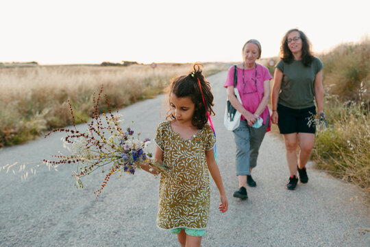 Multigenerational Family Walking At Sunset