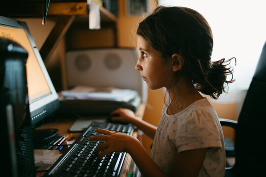Kid working on computer at home