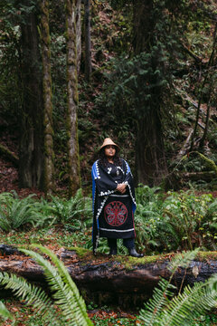 Serious portrait of young woman in indigenous regalia.