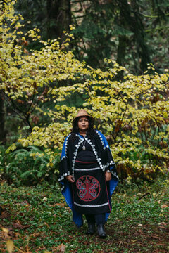 Serious portrait of young woman in indigenous regalia.