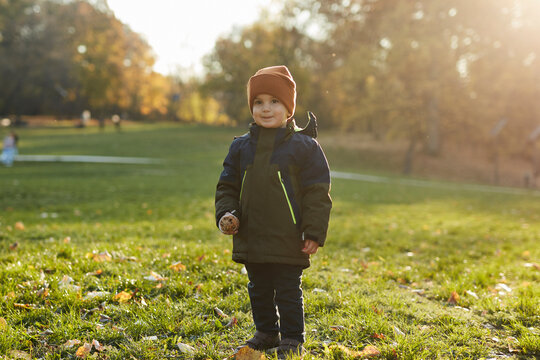 Little Boy Standing On A Lawn