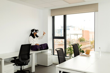 Business woman using virtual reality glasses in office
