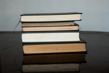 books on top of each other on wooden table