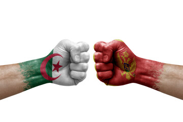 Two hands punch to each others on white background. Country flags painted fists, conflict crisis concept between algeria and montenegro