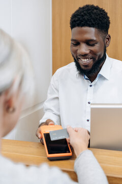 Patient makes payment at dental surgery 