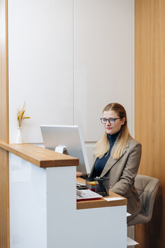 Woman administrator stands in a clinic at the reception