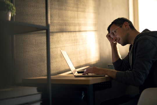 Man Using A Laptop Home