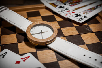 watch with playing cards on a table