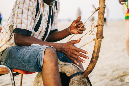 Unrecognizable Africa man playing kora