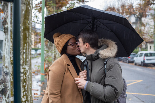 love, couple kissing under umbrella under rain, dating
