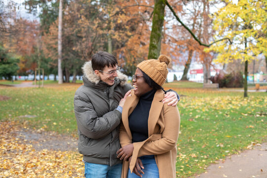 hug, couple laughing outside, rainy cold weather