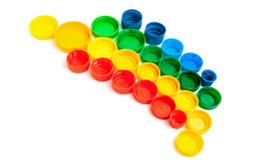 Colored screw caps for plastic bottles used to seal plastic bottles on a white background. Used bottle caps collected for plastic recycling. Separate waste sorting.
