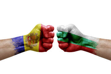 Two hands punch to each others on white background. Country flags painted fists, conflict crisis concept between andorra and bulgaria