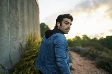Stylish man in city park inevening