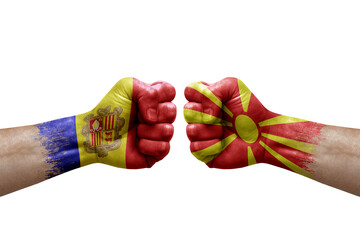 Two hands punch to each others on white background. Country flags painted fists, conflict crisis concept between andorra and north macedonia