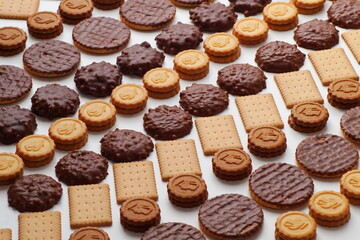 Pattern of cookies of different types and shapes stacked in even rows diagonally