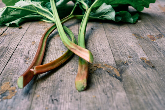 Rhubarb stalks on wooden background