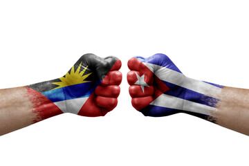Two hands punch to each others on white background. Country flags painted fists, conflict crisis concept between antigua and barbuda and cuba