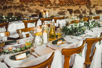 Served tables in a rustic banquet hall 