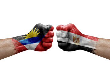 Two hands punch to each others on white background. Country flags painted fists, conflict crisis concept between antigua and barbuda and egypt