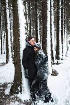 Young couple fooling around in the snowy park