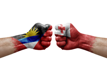 Fototapeta premium Two hands punch to each others on white background. Country flags painted fists, conflict crisis concept between antigua and barbuda and tonga