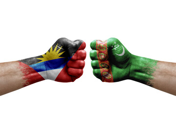 Two hands punch to each others on white background. Country flags painted fists, conflict crisis concept between antigua and barbuda and turkmenistan