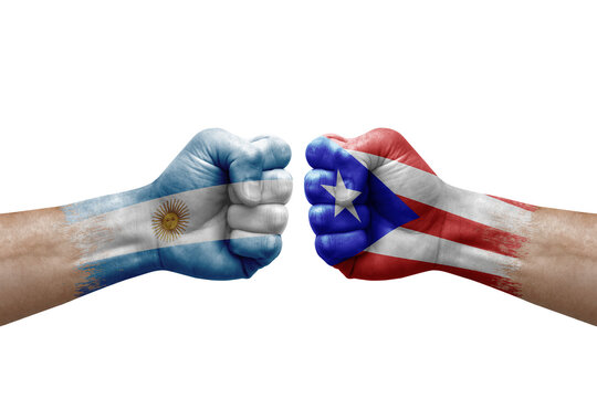 Two hands punch to each others on white background. Country flags painted fists, conflict crisis concept between argentina and puerto rico